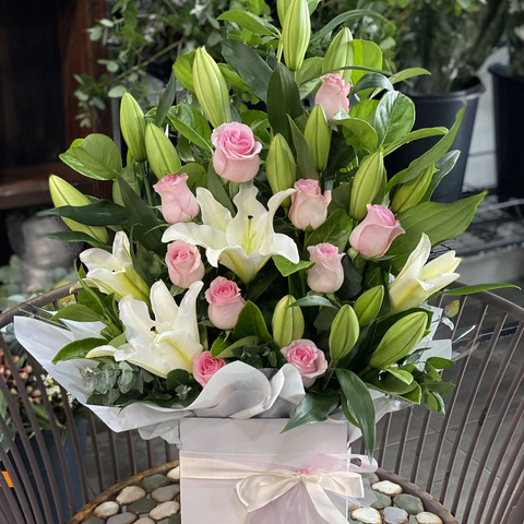 Blushing pink rose and white oriental lily arrangement